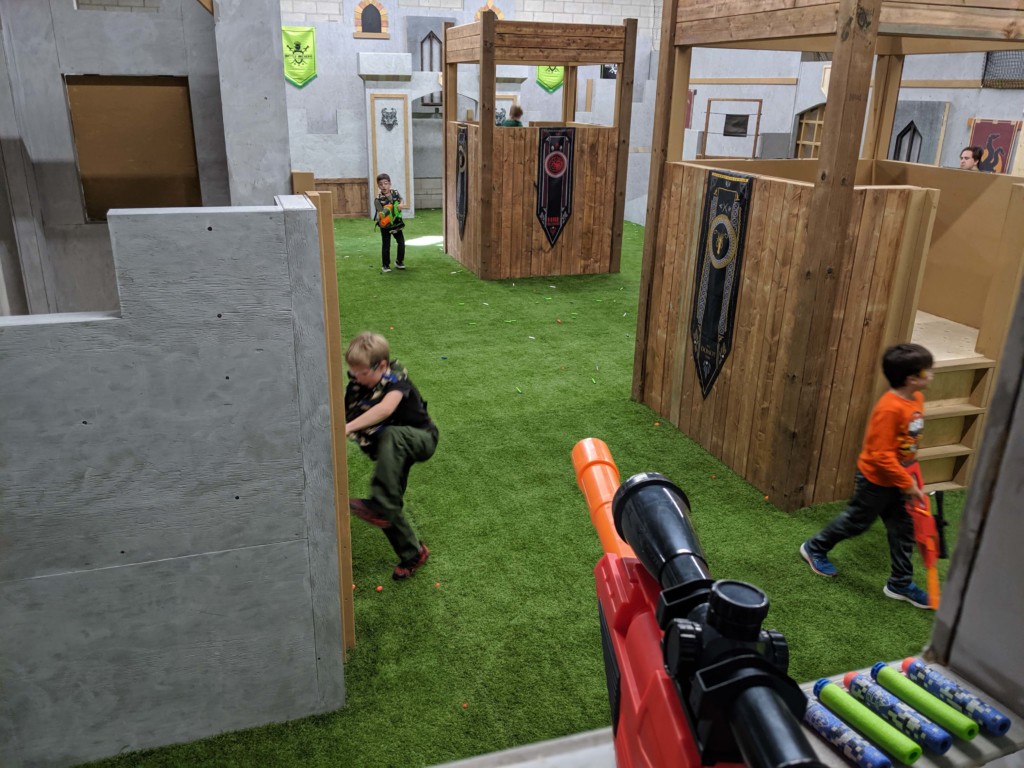 birthday boy picking up a nerf gun